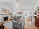 Bright living room with hardwood floors, fireplace, and comfy seating at 2532 Governors Pointe Ne Ct, Concord, NC 28025