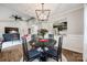 Bright dining room with dark wood table and chairs, view into living room and kitchen at 2722 Hillmont Dr, Charlotte, NC 28226