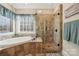 Spa-like bathroom with a large soaking tub, glass shower, and tile at 4006 Sincerity Rd, Monroe, NC 28110