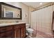 Bathroom with a dark wood vanity, granite countertop, and decorative shower curtain at 4006 Sincerity Rd, Monroe, NC 28110