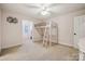 Bright bedroom with a white loft bed, ceiling fan and adjoining room with natural light at 4006 Sincerity Rd, Monroe, NC 28110