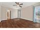 Bedroom with hardwood floors, ceiling fan, and large windows offering abundant natural light at 4006 Sincerity Rd, Monroe, NC 28110