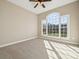 Bright, carpeted bedroom with a large window offering natural light and backyard views at 4006 Sincerity Rd, Monroe, NC 28110