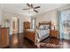 Bedroom with hardwood floors, wooden bed frame, and large windows at 4006 Sincerity Rd, Monroe, NC 28110