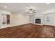 Bright living room featuring a fireplace, hardwood floors, and large windows at 4006 Sincerity Rd, Monroe, NC 28110