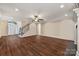 Spacious living room showcases hardwood flooring, a fireplace, and staircase at 4006 Sincerity Rd, Monroe, NC 28110