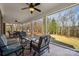 Enclosed patio with ample seating offers a beautiful transition to the outdoor space and scenic backyard at 4006 Sincerity Rd, Monroe, NC 28110