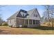 A view of the back exterior of a beautiful home, featuring a screened in porch and brick detailing at 4006 Sincerity Rd, Monroe, NC 28110