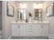 Bathroom with double vanity, white cabinets, modern fixtures, and neutral walls at 405 Newstyle Way # 1, Cramerton, NC 28056