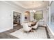 Bright dining room with tray ceiling, chandelier, and light wood table on an area rug at 405 Newstyle Way # 1, Cramerton, NC 28056