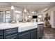 Kitchen island with a farmhouse sink and views of the living area at 405 Newstyle Way # 1, Cramerton, NC 28056