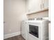 Laundry room featuring modern washer and dryer units, storage cabinets, and neutral wall color at 405 Newstyle Way # 1, Cramerton, NC 28056