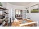 Office with wood desk and shelving leading to bright dining room through double doors at 405 Newstyle Way # 1, Cramerton, NC 28056