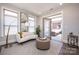 Inviting sunroom features a daybed, modern lighting, and French doors leading to the patio at 405 Newstyle Way # 1, Cramerton, NC 28056