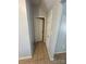 Image shows a hallway with light grey walls and tile floors, leading to other rooms at 507 Brookwood St, Mooresville, NC 28115