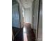 Shows a hallway with dark brown laminate flooring and doors to bedrooms at 507 Brookwood St, Mooresville, NC 28115