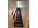 Indoor staircase with wood-look laminate treads and white railing at 507 Brookwood St, Mooresville, NC 28115