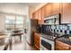 Updated kitchen featuring stainless steel appliances and dark wood cabinets at 525 E 6Th St # 409, Charlotte, NC 28202