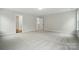 Spacious bedroom with neutral carpet, paint, and trim, with a view into the hallway at 5404 Verona Rd # 36, Charlotte, NC 28213