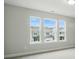 Bedroom with three large windows allowing natural light and a view of the neighborhood at 5404 Verona Rd # 36, Charlotte, NC 28213