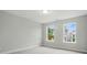 A bright bedroom with two large windows offering natural light and neighborhood views at 5404 Verona Rd # 36, Charlotte, NC 28213