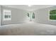 Spacious carpeted bedroom with multiple double-hung windows and neutral paint at 5404 Verona Rd # 36, Charlotte, NC 28213