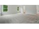 Bedroom with plush carpet and windows providing natural light, painted in neutral colors at 5404 Verona Rd # 36, Charlotte, NC 28213