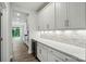 Butler's pantry features white cabinets, marble backsplash, wine cooler, and quartz countertops at 5404 Verona Rd # 36, Charlotte, NC 28213
