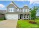 Charming two-story home with gray siding, a two-car garage, and a well-manicured lawn at 5404 Verona Rd # 36, Charlotte, NC 28213