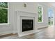 Close-up of cozy fireplace, wood floors, neutral walls, bright natural light, and view of backyard at 5404 Verona Rd # 36, Charlotte, NC 28213