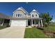 Charming two-story home with gray siding, white trim, two-car garage and manicured lawn at 5404 Verona Rd # 36, Charlotte, NC 28213