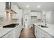 Well lit kitchen with white cabinets, stainless steel appliances, and a view into the house at 5404 Verona Rd # 36, Charlotte, NC 28213