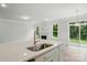 Bright kitchen featuring a central island, wood flooring, stainless steel appliances, and a view to the backyard at 5404 Verona Rd # 36, Charlotte, NC 28213
