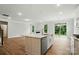 Bright kitchen featuring a central island, wood flooring, stainless steel appliances, and a clear view to the fireplace at 5404 Verona Rd # 36, Charlotte, NC 28213