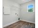 Laundry room with wood-look floors, shelving, and ample space for laundry appliances at 5404 Verona Rd # 36, Charlotte, NC 28213