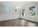 Bright and airy living room featuring stylish wood floors and large windows offering scenic views at 5404 Verona Rd # 36, Charlotte, NC 28213