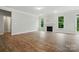 Open-concept living room featuring wood floors, a cozy fireplace, and ample natural light at 5404 Verona Rd # 36, Charlotte, NC 28213