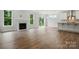Open-concept living room features wood floors, fireplace, lots of natural light, and view of kitchen at 5404 Verona Rd # 36, Charlotte, NC 28213