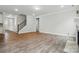 Bright and spacious living room featuring wood floors, a staircase, and neutral decor at 5404 Verona Rd # 36, Charlotte, NC 28213