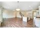 Spacious open-concept living area with wood floors, staircase, kitchen island and lots of natural light at 5404 Verona Rd # 36, Charlotte, NC 28213