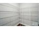 Walk-in pantry with white painted wire shelving and wood-look flooring at 5404 Verona Rd # 36, Charlotte, NC 28213