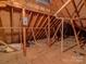 Bright attic featuring exposed rafters and beams, showing insulation and utility components at 5529 Five Knolls Dr, Charlotte, NC 28226