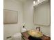 Powder room featuring artistic glass bowl sink, modern fixtures, and neutral wall art at 5529 Five Knolls Dr, Charlotte, NC 28226