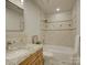 Well-lit bathroom featuring a tile surround tub and granite vanity top at 5529 Five Knolls Dr, Charlotte, NC 28226