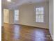 Spacious bedroom featuring hardwood floors, walk-in closet, and natural light at 5529 Five Knolls Dr, Charlotte, NC 28226