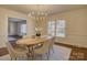 Bright dining room with hardwood floors and a modern chandelier at 5529 Five Knolls Dr, Charlotte, NC 28226