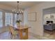 Bright dining room featuring modern chandelier, large windows, and view of living room at 5529 Five Knolls Dr, Charlotte, NC 28226