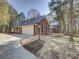 Brick home exterior featuring a driveway, manicured lawn, and elegant brick walkway at 5529 Five Knolls Dr, Charlotte, NC 28226