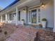 Inviting brick porch with decorative plants and lantern-style lighting at 5529 Five Knolls Dr, Charlotte, NC 28226