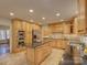 Open kitchen featuring an island, custom cabinets, and modern appliances at 5529 Five Knolls Dr, Charlotte, NC 28226